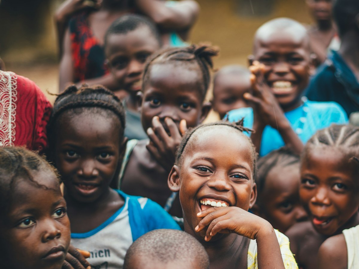 A crowd of laughing children gathered close together